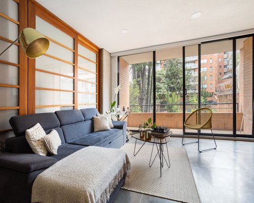 Warm interior apartment setup in Bogota with side window lighting and soft ambient lamps